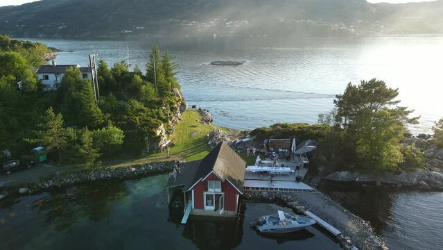 Norway's wooden cabin on fjord coast, drone footage