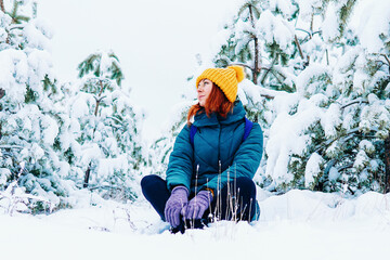 Fototapeta na wymiar Young smiling woman enjoys snowy winter day. High quality photo