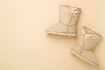 Beautiful woman ugg boots on color background,top view