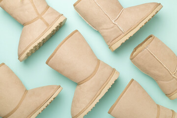 Many woman ugg boots on color background,top view