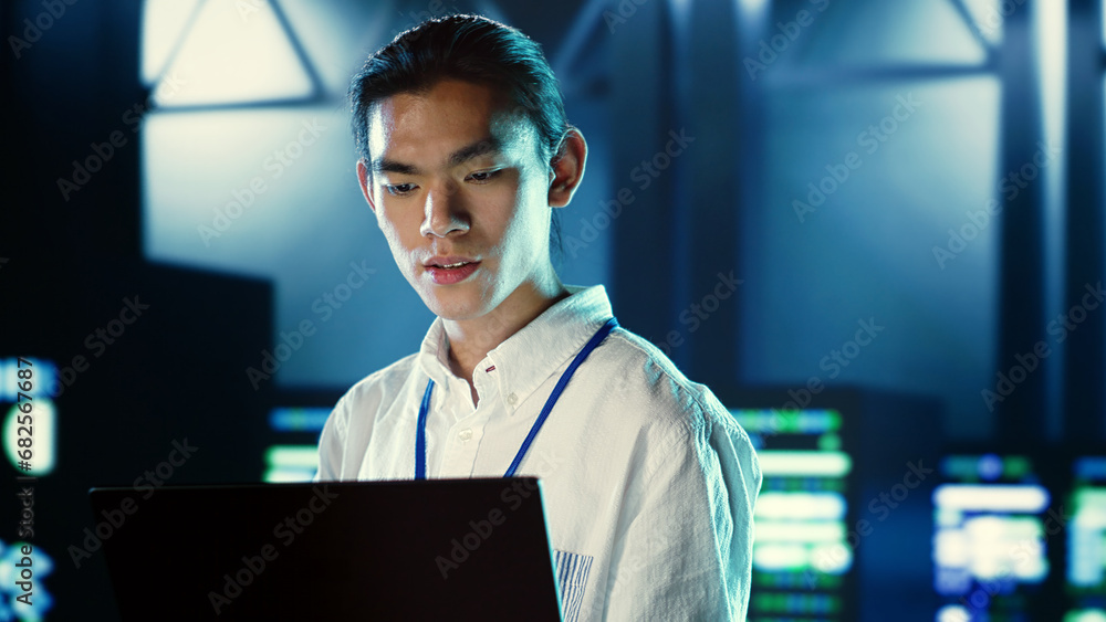 Poster skillful employee walking through data center systems providing processing resources for different w