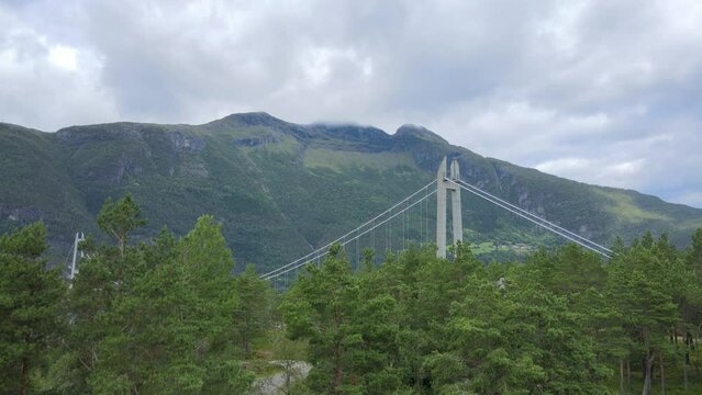 Hardanger Bridge in Norway on a cloudy, flying from woods