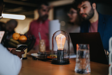 Late night collaboration of coworkers discussing project details leads to business growth.