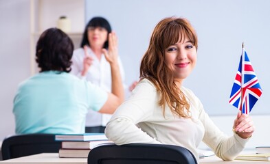 Old female english teacher and students in the classroom