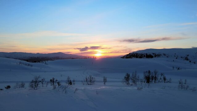 Sunset over snowy hills in Voss, Norway