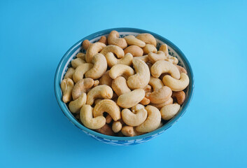 Bowl or dish of raw organic cashews that are salted and roasted