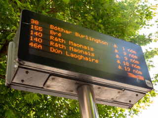 Dublin, Ireland - 05-27-2023 : Daylight. Electronic timetables at a bus stop on O Connell Street.