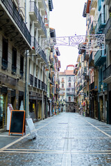 Pamplona's iconic Estafeta Street, overcast.