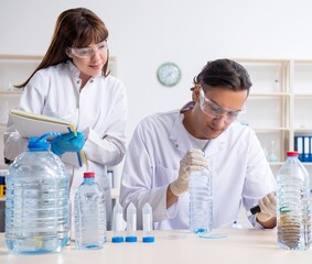 Two chemists working in the lab
