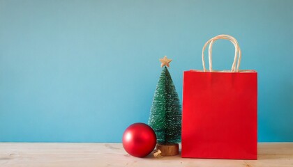 Christmas Bag with holiday props on a solid background with a tree, hat, and balls. 