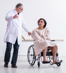 Old male doctor psychiatrist and patient in wheel-chair