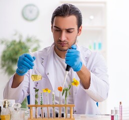 Young male chemist in perfume synthesis concept