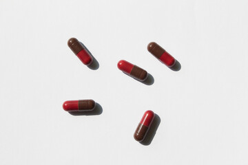 red and brred and brown color pills on a white backgroundown color pills on a white background