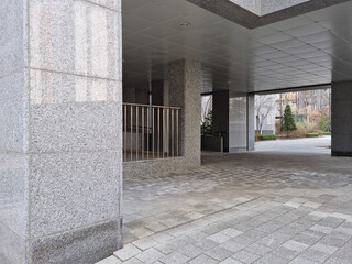 It is at the bottom of the building with sidewalk blocks.