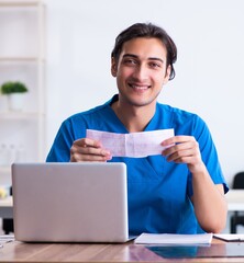 Young male doctor cardiologist working in the clinic