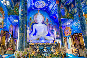 Blue Interior of Wat Rong Suea Ten,with white Buddha statue,Chiag Rai,Northern Thailand,Southeast Asia.