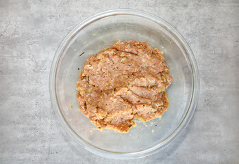 Ground turkey meat mixed with eggs, rice, onion, garlic, oregano, fresh mint, salt and pepper for making the meatballs for turkey albondiga soup.