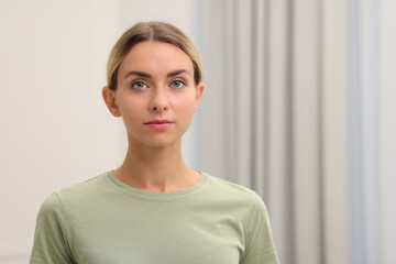 Portrait of beautiful woman indoors, space for text