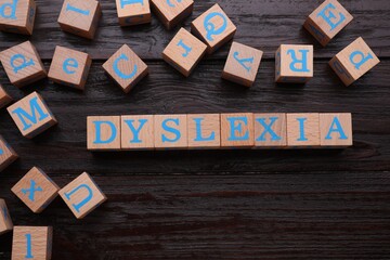 Cubes with word Dyslexia on wooden background, flat lay - obrazy, fototapety, plakaty