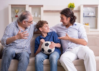 Boy and his father and his grandfother indoor