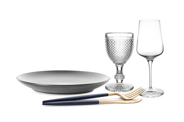 Clean plate, cutlery and glasses on white background