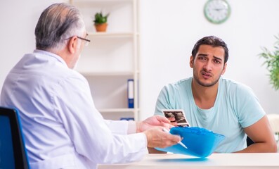 Young male patient visiting experienced doctor