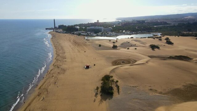 Flying in reverse along the shore of Maspalomas beach and spotting the Maspalomas lighthouse.
