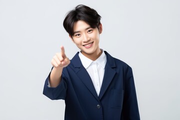 Business woman pointing finger at you on isolated white background.