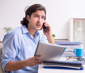 Young male employee working at home