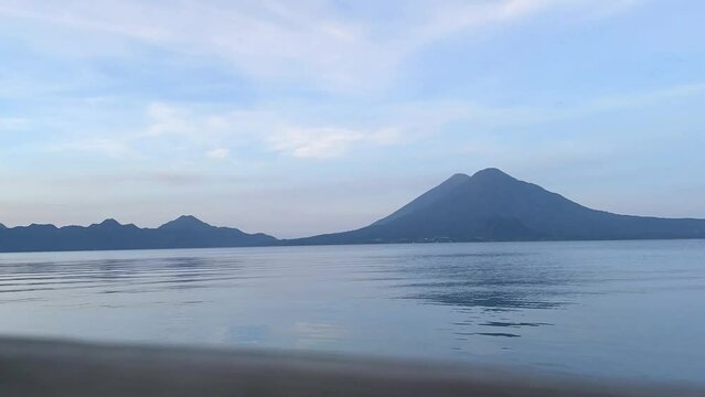Time lapse sunrise HD video footage of dawn on Lake Atitlan Guatemala with volcanoes in the background