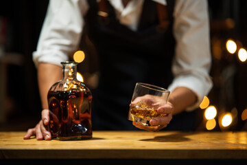 Barman pouring whiskey whiskey glass..