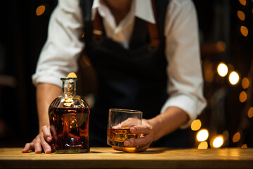 Barman pouring whiskey whiskey glass..