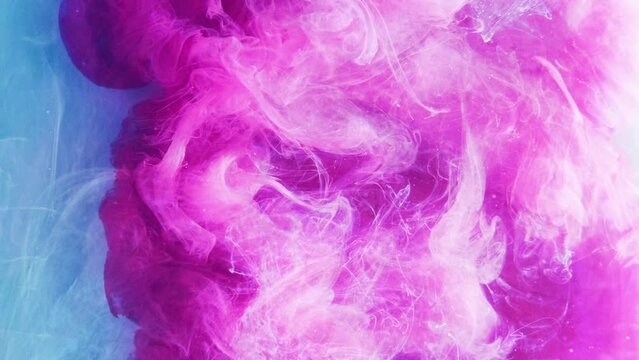 Vertical video. Smoke cloud background. Fantasy splash. Magenta purple pink paint ink hypnotic flow spreading in blue water abstract explosion illusion art.