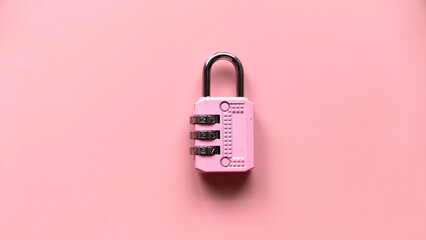 Safety and protection concept. Pink padlock isolated on a pink background