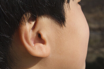 Ear of child or ear of boy.