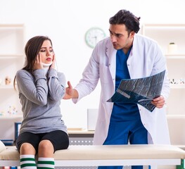 Fototapeta premium Young male doctor and female beautiful patient