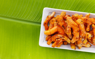 Turmeric roots on banana leaf