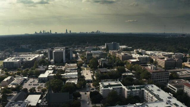 Left to right aerial shot of downtown Decatur Georgia with the Atlanta Skyline in the background.