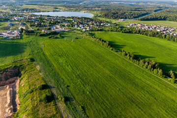 Fototapeta premium Aerial landscape with a view of the countryside with green fields and village houses