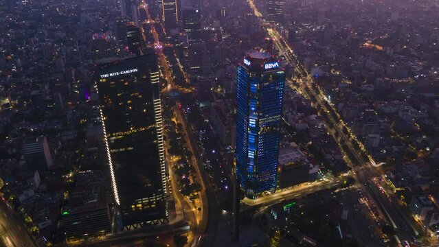 Aerial hyperlapse of skyscraper flashing lights as cars zoom by at night, Mexico City
