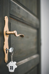 door handle and key in the keyhole with house pendant. Ideal photo for real estate and financial...