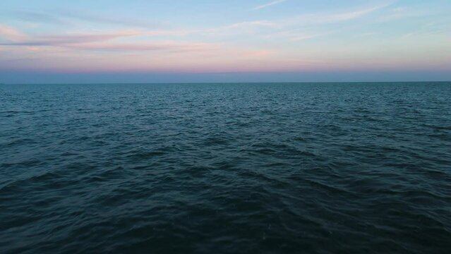 Sky seamlessly blends into ocean water ripples, zen calming nature background of water