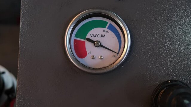 Camera zooms out revealing a Vacuum Gauge, Auto Shop, Bangkok, Thailand
