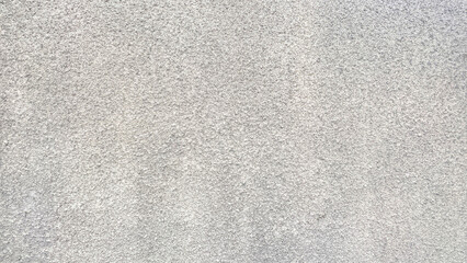 Abstract background. The wall decorated with putty. An old textured gray wall.