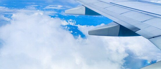 Fototapeta na wymiar Beautiful nature of blue sky and clouds through an airplane window. Travel concept, traveler, trip, vacation, tourism, background