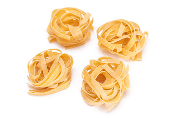 Four Classic Italian Raw Egg Fettuccine - Isolated on White Background. Dry Twisted Uncooked Pasta. Italian Culture and Cuisine. Raw Golden Macaroni Pattern - Isolation