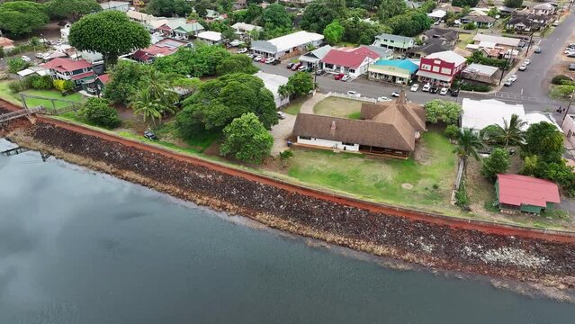 Aerial Kauai Hawaii Hanapepe Swinging Bridge city. Hanapepe River flow Pacific Ocean through historical town. Swinging suspension bridge sways as you cross it. Historically plantation style buildings.