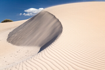 Light blowing sand on dune near Exmouth, Gascoyne region of Western Australia.