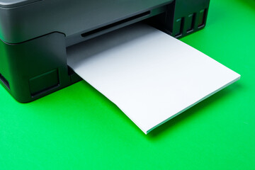 Modern printer with paper on green background
