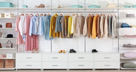 Big wardrobe with clothes in dressing room